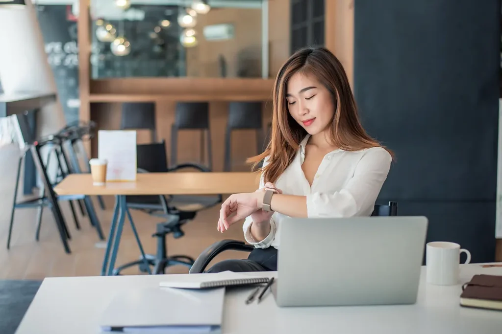 Young entrepreneur at her desk dressed very nicely who is mastering being productive