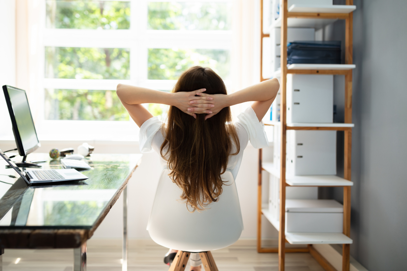 Entrepreneur taking it easy at her desk in her home office